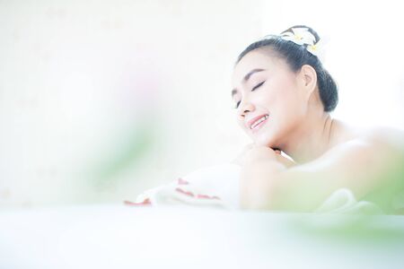Asian woman lying in bed, spa, Thai massage, spa