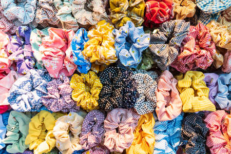 Colorful elastic rings. Girl elastic fashion band. hair scrunchy. A scrunchie is a fabric covered rubber band hair used to fasten long hair.の写真素材