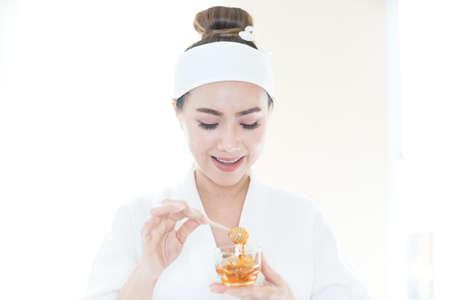 Beautiful woman masking skin in a facial spa shop