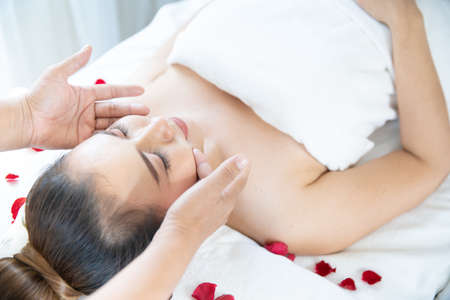 Beautiful woman in spa. A beautiful woman is doing facial massage in a spa shop.の写真素材