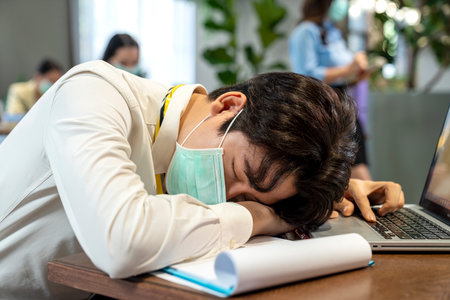Company employees sick from viral infection. Covid virus 19. Employees at workplace during pandemic. Employees wear protective masks to prevent PM 2.5 dust and virus COVID-19.の写真素材