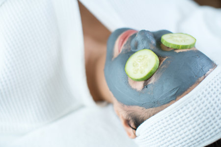 Woman hands lay hot stones on woman backs on spa table. A young woman is spaing with hot stones at a spa shop in Bangkok, Thailand.の写真素材