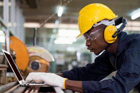 A worker at the factory. New steel pipes. Engineer is holding in hands a pipe tool. Tube tool.