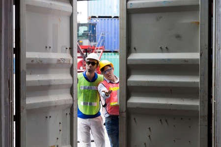 Foreman and staff are opening containers to check stock.