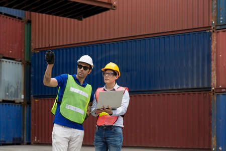 Foreman showing thumbs up on Forklifts in the Industrial Container Cargo freight ship.の写真素材