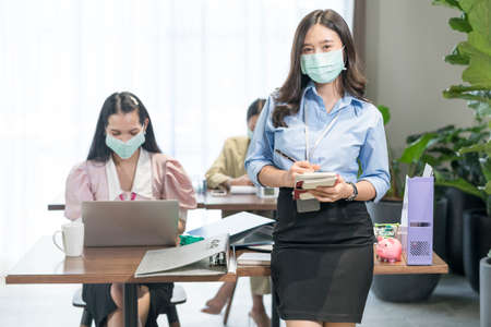 Workers of financial company, Employees at companies wearing masks to prevent COVID 19. New Normal and Social Responsibility in the face of coronavirus.の写真素材