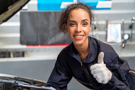 Car repairs. Auto services and Small business concepts. A car mechanic showing thumb up.の写真素材