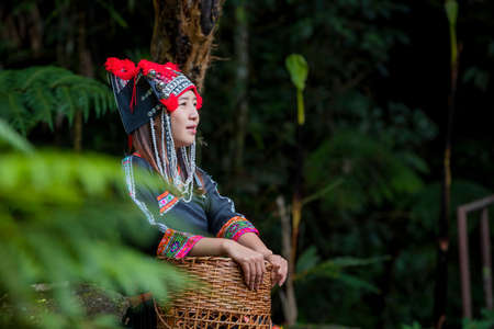 A young hill tribe woman is playing in the water on the waterfall.の写真素材