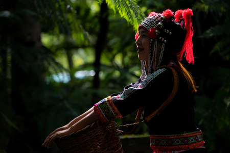 hill tribe girl walking in the forest. Hmong hill tribe clothes.の写真素材