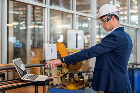 The factory manager using laptop. Engineers and technicians are working in industrial plants.の写真素材