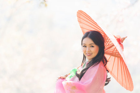 Teenage girl wearing hanbok Korean national costumes in famous tourist attractions in Seoul, South Koreaの写真素材