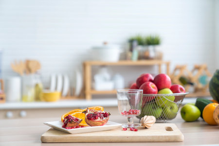 Preparation of freshly squeezed pomegranate juice. Pomegranate drink on the table. Space for text.