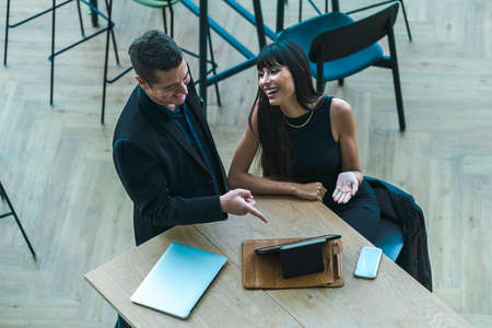 Businessman and Businesswoman Excited over a successful project in Co-Working space. Excited...