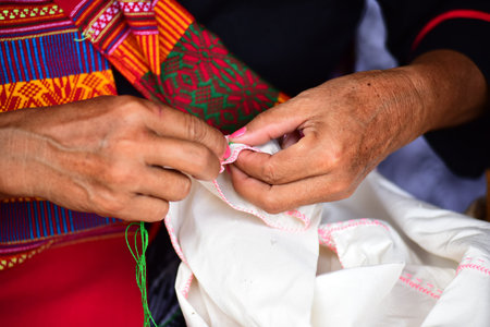 Phu Thai of an ethnic woman in a dress. Woman sewing clothes in cotton nature.の写真素材