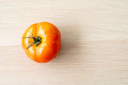 Red tomatoes on the wooden floor. Fresh red tomatoes on the wooden table.の写真素材