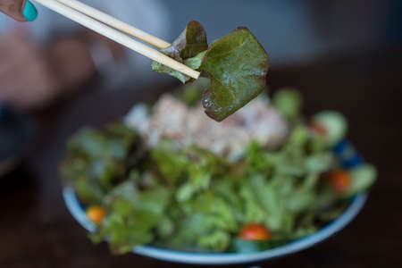 Healthy living and Vegan food. Cooking vegan food. Japanese Salad vegetables in a bowl are placed on...