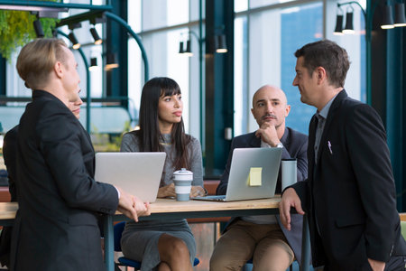businessman Colleagues Meeting Team. business people talking in Co Working space office. Group of people in formalwear discussing something while working in the modern office.の写真素材