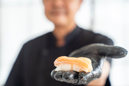Closeup of chef hands japanese food, Japanese chef making sushi at restaurant.の写真素材