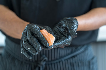 Process of making sushi. chef is preparing japan tradition cookery. The process of making and decorating salmon sushi.の写真素材