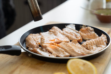 Japanese Chef sprinkle salt on salmon meat. Japanese Cuisine food, using gas burner torch.の写真素材