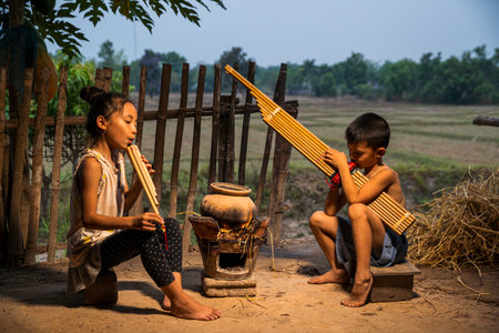 Rural children playing with blowing music and laughter. People Thailand. Boys and girls playing folk...