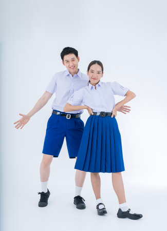 Thai students. Asian girl and boy in students uniform on white background.の写真素材