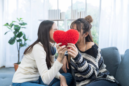 Lgbtq Concept. Two young women holding a red heart symbolizing the LGBT community.の写真素材