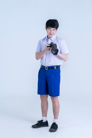 Students in Thai uniforms looking at cameras. Happy teen high school student.の写真素材