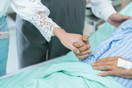 Image of holding hands and giving support to elderly patients.の写真素材