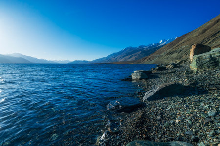 Pangong Lake. Blue salt water contrast with yellow rock mountain area Leh Ladakh, North India.