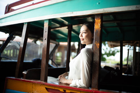 Vietnamese woman on a bus in rural Vietnam. Ao dai is famous traditional costume for women in Vietnam.の写真素材