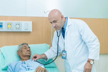 The doctor is examining a patient on the bed. The doctor used a stethoscope to listen to the...