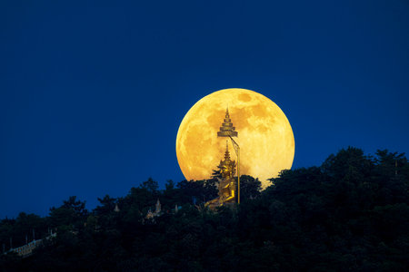 Full moon over Buddha statue in Chiang Mai, Thailandの写真素材