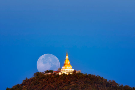 Full moon at Wat Phra That Mon Luang, Chiang Rai Province, Thailand.の写真素材