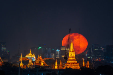 Big Moon with Golden Mount Bangkok and Thonburi Pagoda of Wat Arun in Bangkok, Thailand.のeditorial素材
