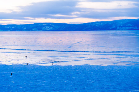 Tourists walk on a frozen river in Baikal, Irkutsk Oblast, Russia.の写真素材