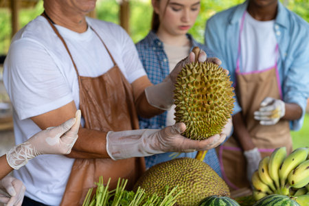 Farmers show off their fruits in their orchards.の写真素材