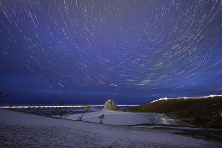 Starry Night over Shaman Rock. Beautiful startrail image during the night  Lake Baikal in southern Siberia, Russia.の写真素材