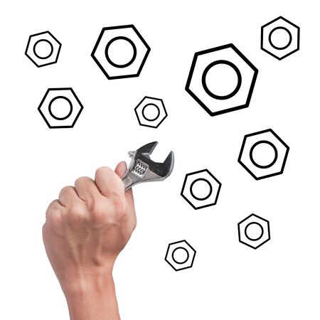 Hand holding wrench with nutsの写真素材