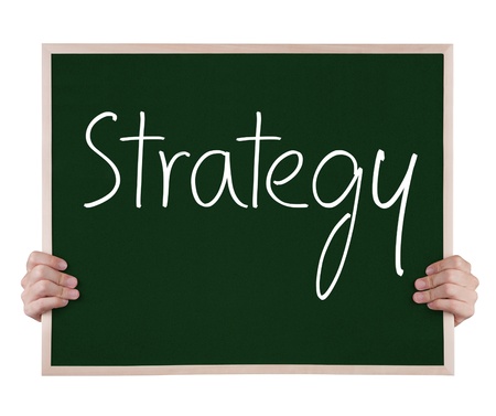 strategy on blackboard with handsの写真素材