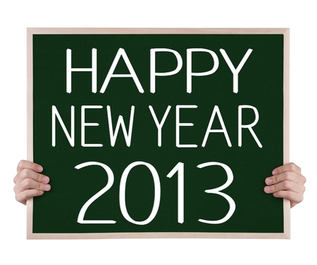 happy new year 2013 on blackboard with handsの写真素材