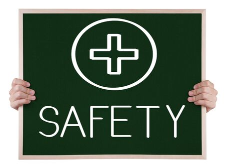 safety sign on blackboard with handsの写真素材