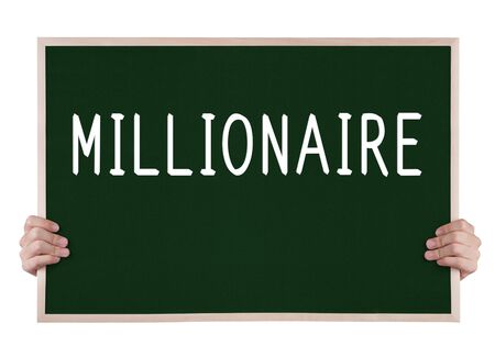 millionaire on blackboard with handsの写真素材