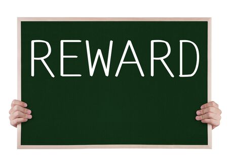 reward on blackboard with handsの写真素材
