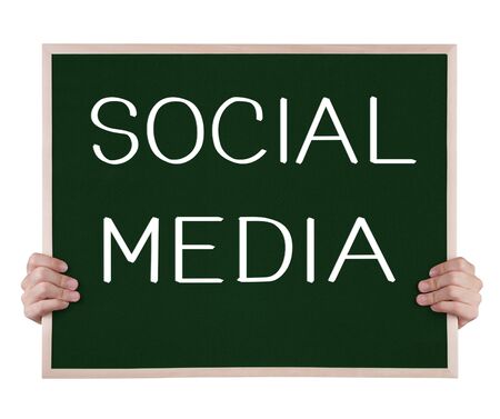 social media on blackboard with handsの写真素材