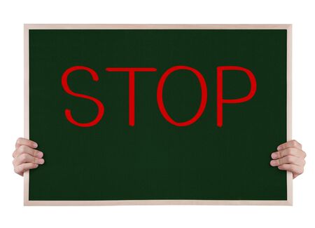 stop on blackboard with handsの写真素材