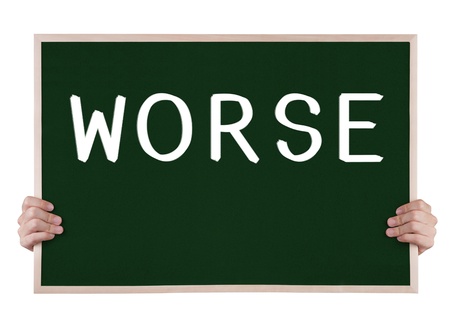 worse on blackboard with handsの写真素材