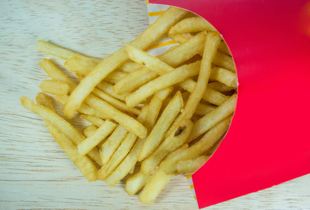 French fires in red box on a wood background.