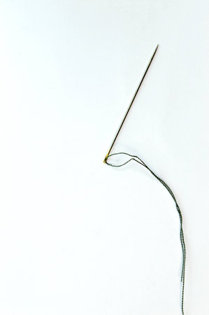 Sewing needle and thread on white background.の写真素材