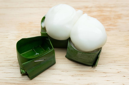 Ta-go Thai dessert, Pudding with coconut topping placed on a wooden background.の写真素材